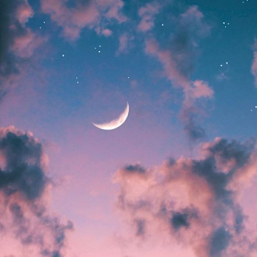 A crescent moon shining amid scattered clouds and twinkling stars in a colorful twilight sky.