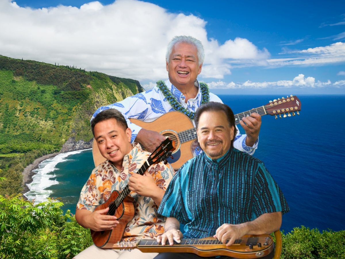 Three men are playing string instruments with a scenic coastal landscape as the backdrop.